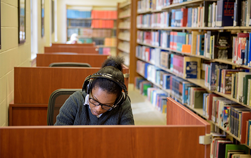 student studying in library